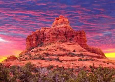 Sedona vs Scottsdale: Which Arizona Destination Is Right for You? Bell Rock in Sedona glowing red under a pink and purple sunset sky