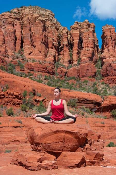 Meditation Sedona - person meditating among the red rock formations in Sedona Arizona