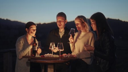 friends enjoying wine and local cheese in the winery beautiful sunset and mountains in SBI 351221419