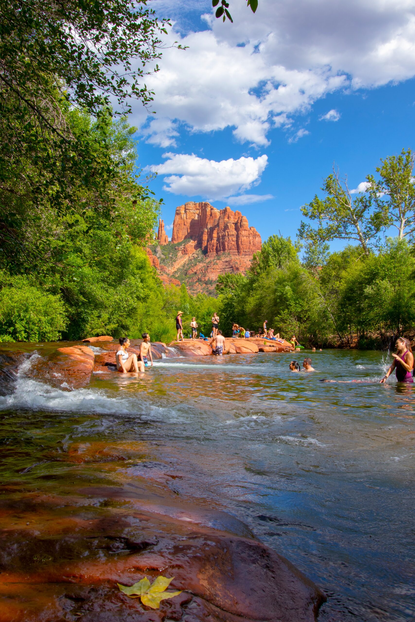People enjoying Oak Creek at Crescent Moon Picnic Site near Red Rock Crossing