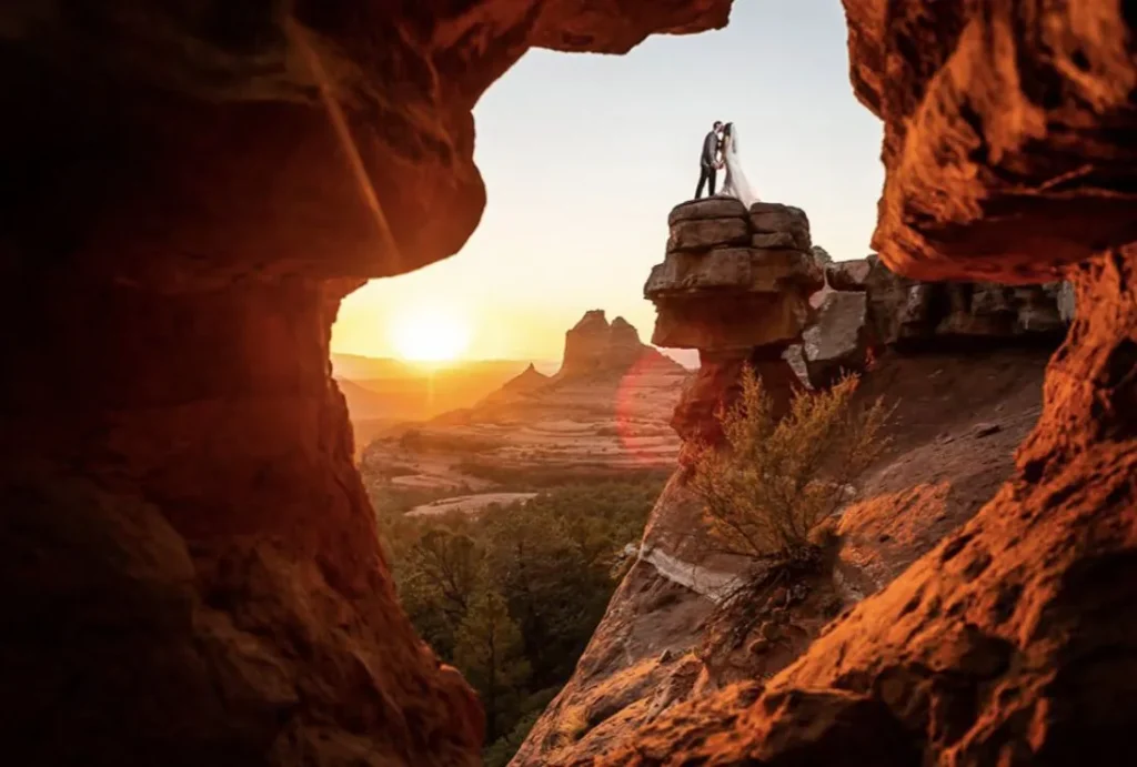 Visit Sedona, Arizona: A Top Global Travel Destination for 2027. Couple framed by a red rock arch at sunset