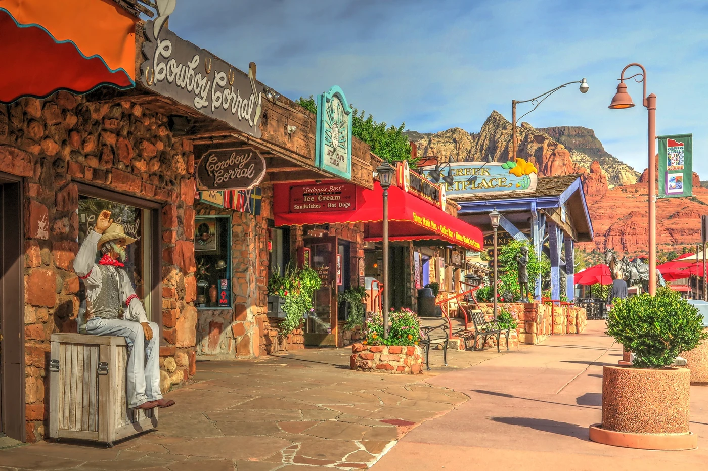 A shopping street with red rock views